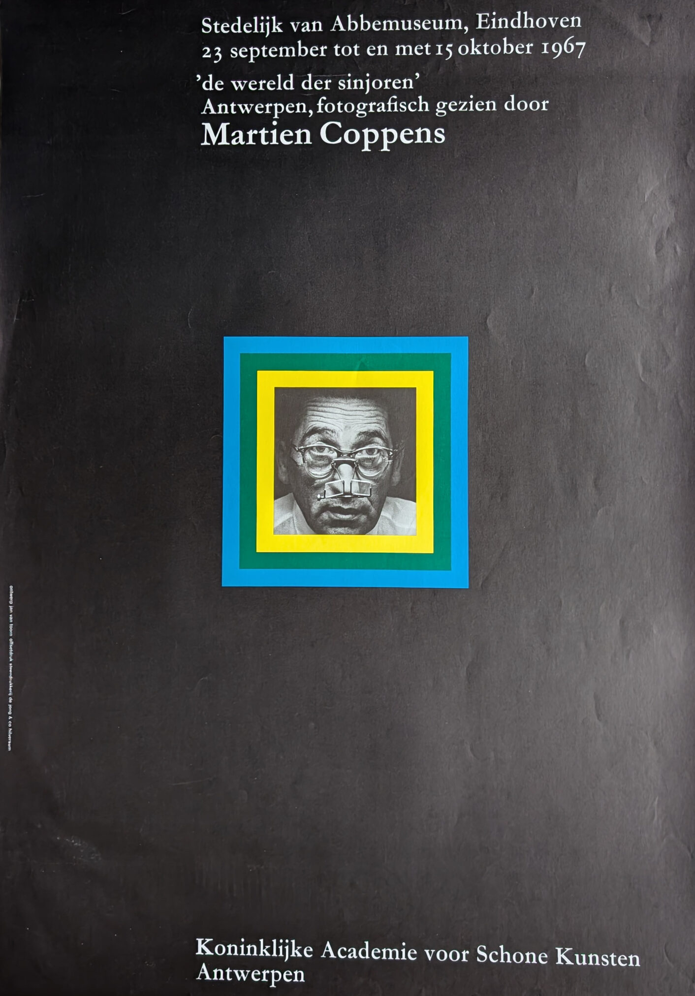 A vintage exhibition poster for Martien Coppens, featuring a black and white image of a man, framed by colorful geometric borders in blue, yellow, and green. The poster includes text detailing the exhibition location and dates at the Stedelijk van Abbe Museum in Eindhoven.